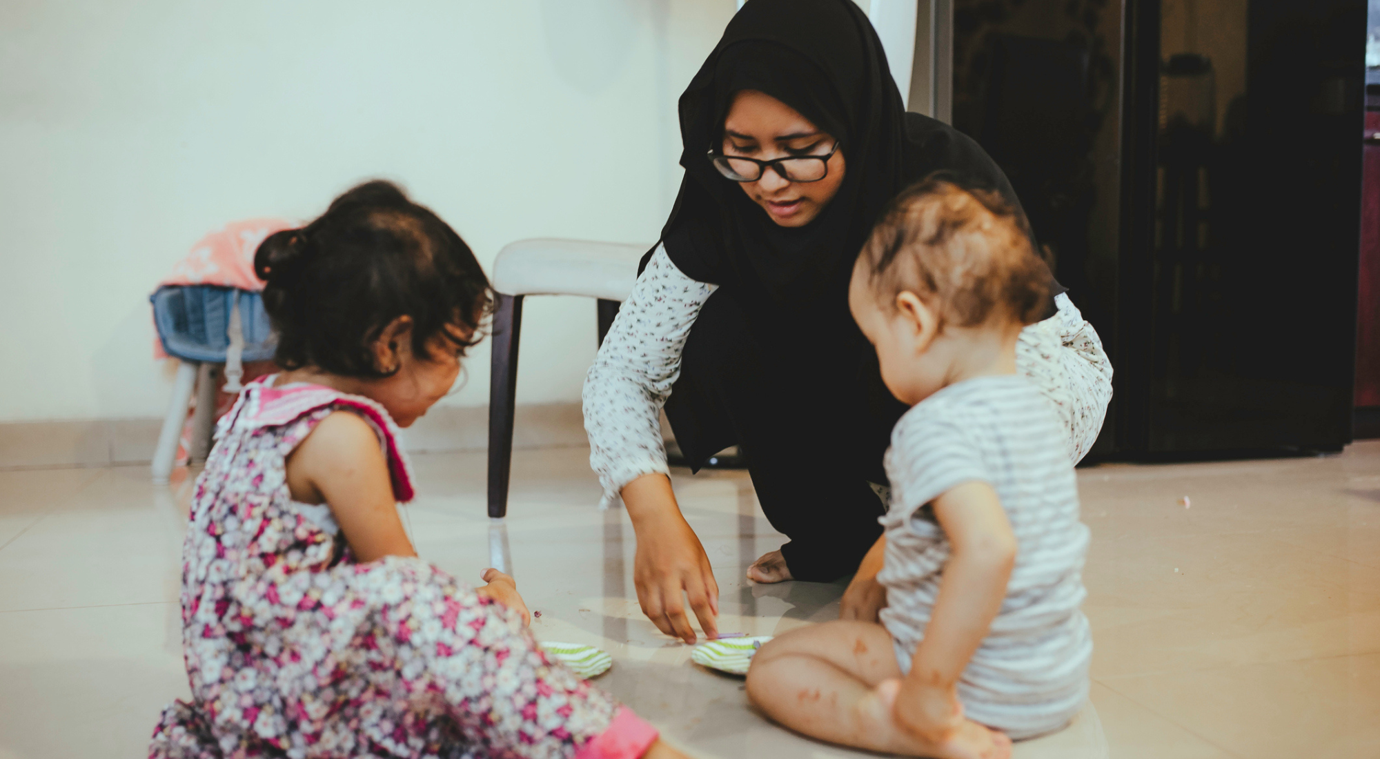 Indian Muslim Woman playing with two children