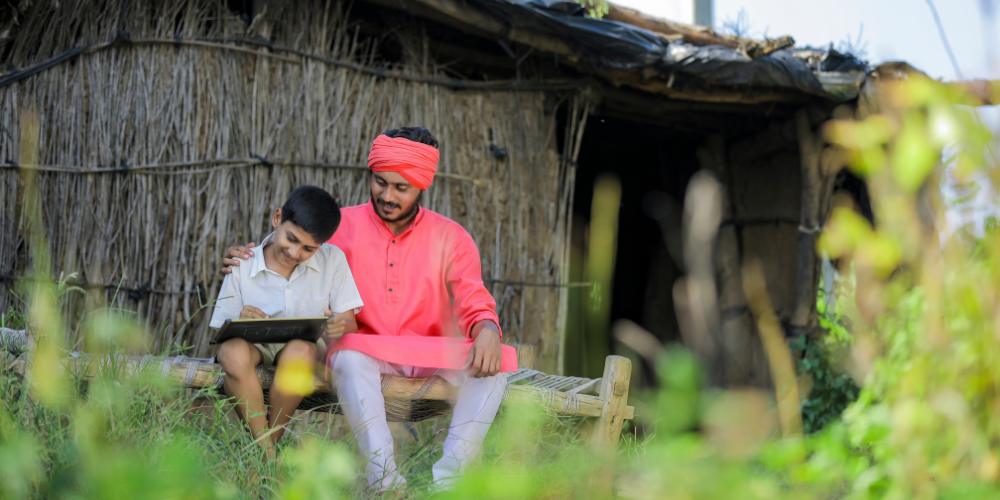 Indian Father and son sitting together doing homework