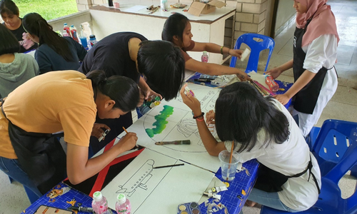 Young people in Thailand creating art as part of a research project